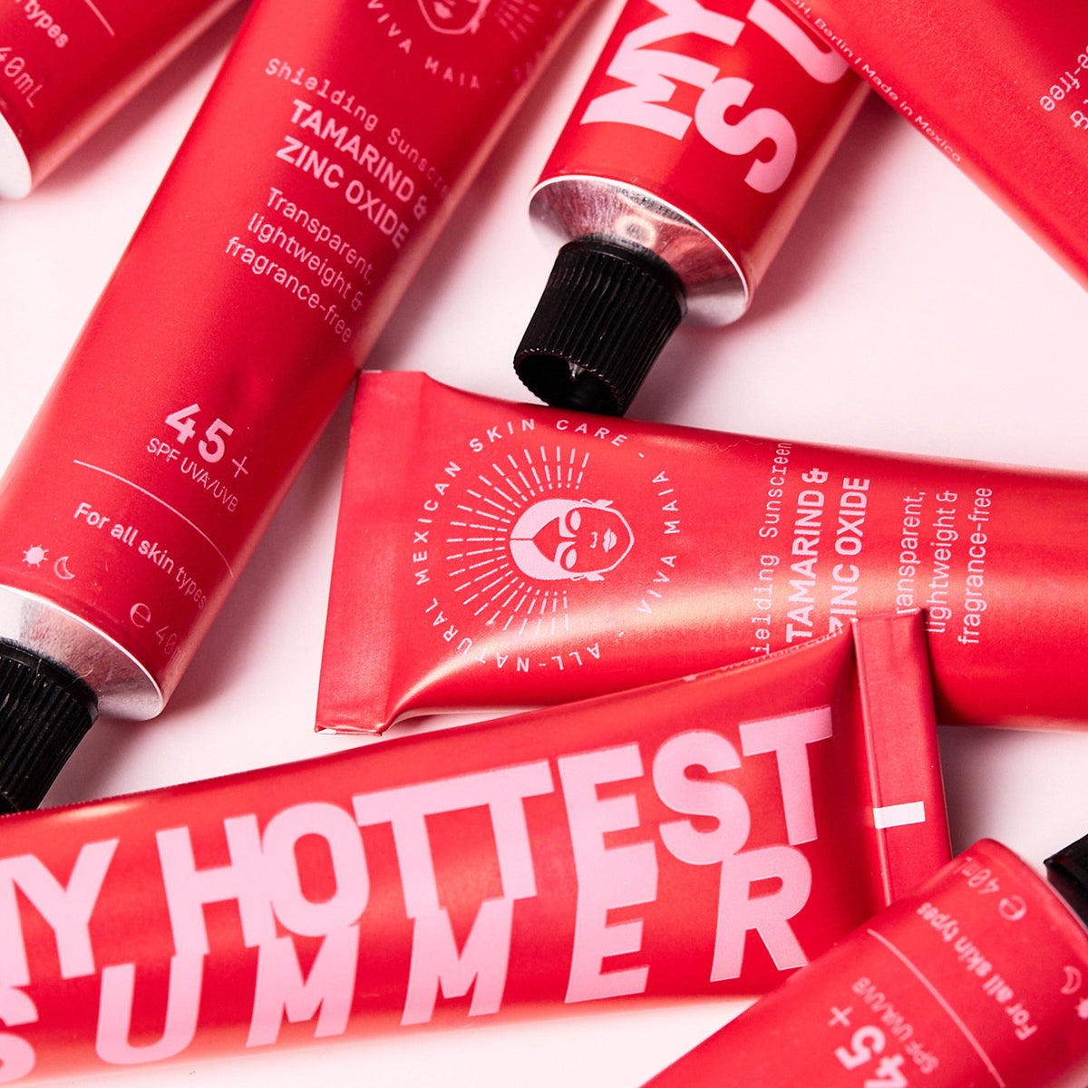 Viva Maia Tamarind & Zinc Oxide Shielding Sunscreen SPF 45+ in red My Hottest Summer tubes on a pale pink background.